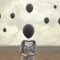 surreal image of woman and blacks balloons flying